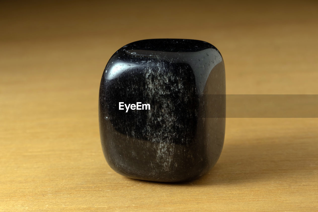 Black onyx polished gemstone from china over a wooden table