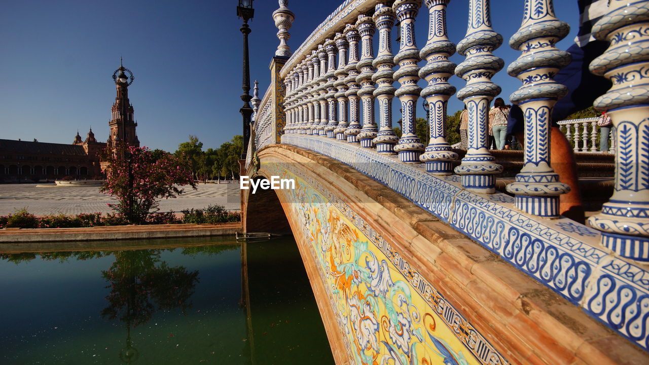 Footbridge over pond against sky at plaza de espana