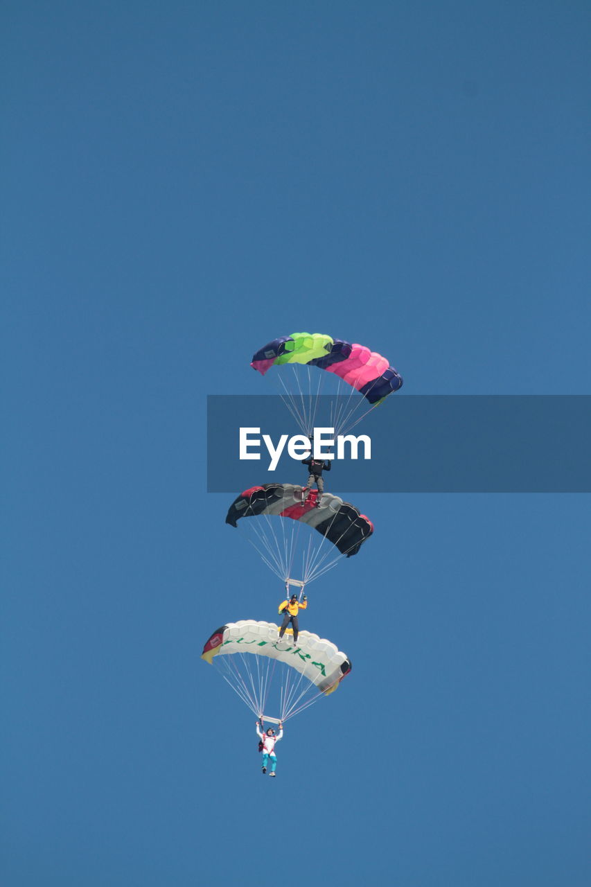 LOW ANGLE VIEW OF COLORFUL BALLOONS AGAINST CLEAR BLUE SKY