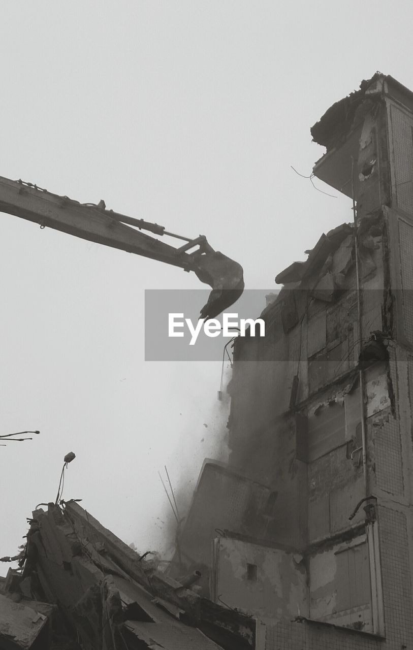 View of demolishing house with bulldozer