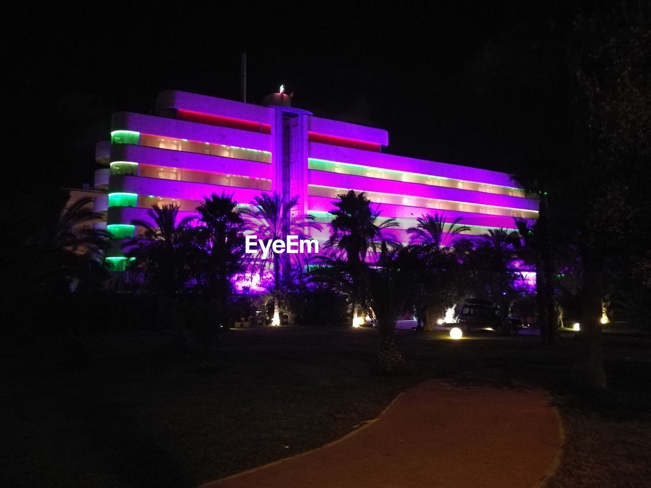 LOW ANGLE VIEW OF ILLUMINATED BUILDING AGAINST SKY