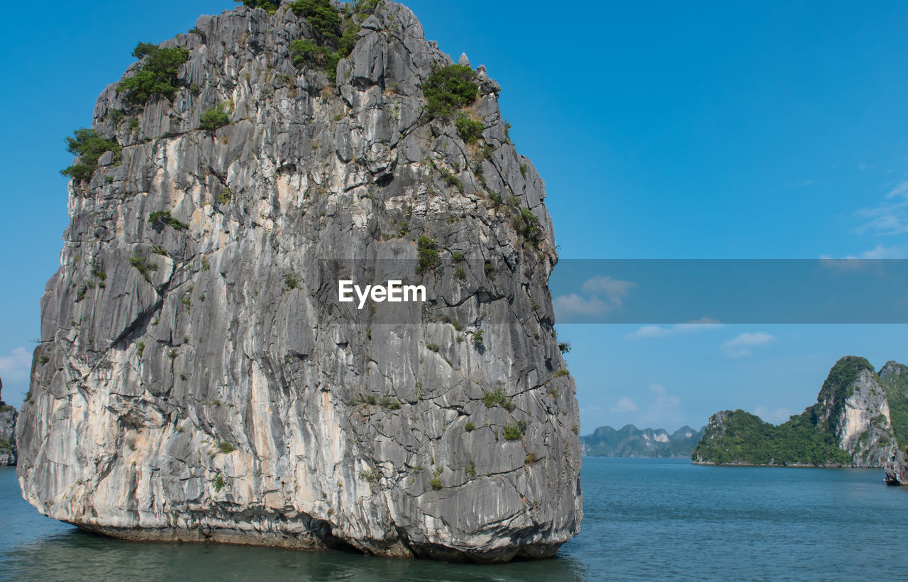 Rock formation in sea against sky