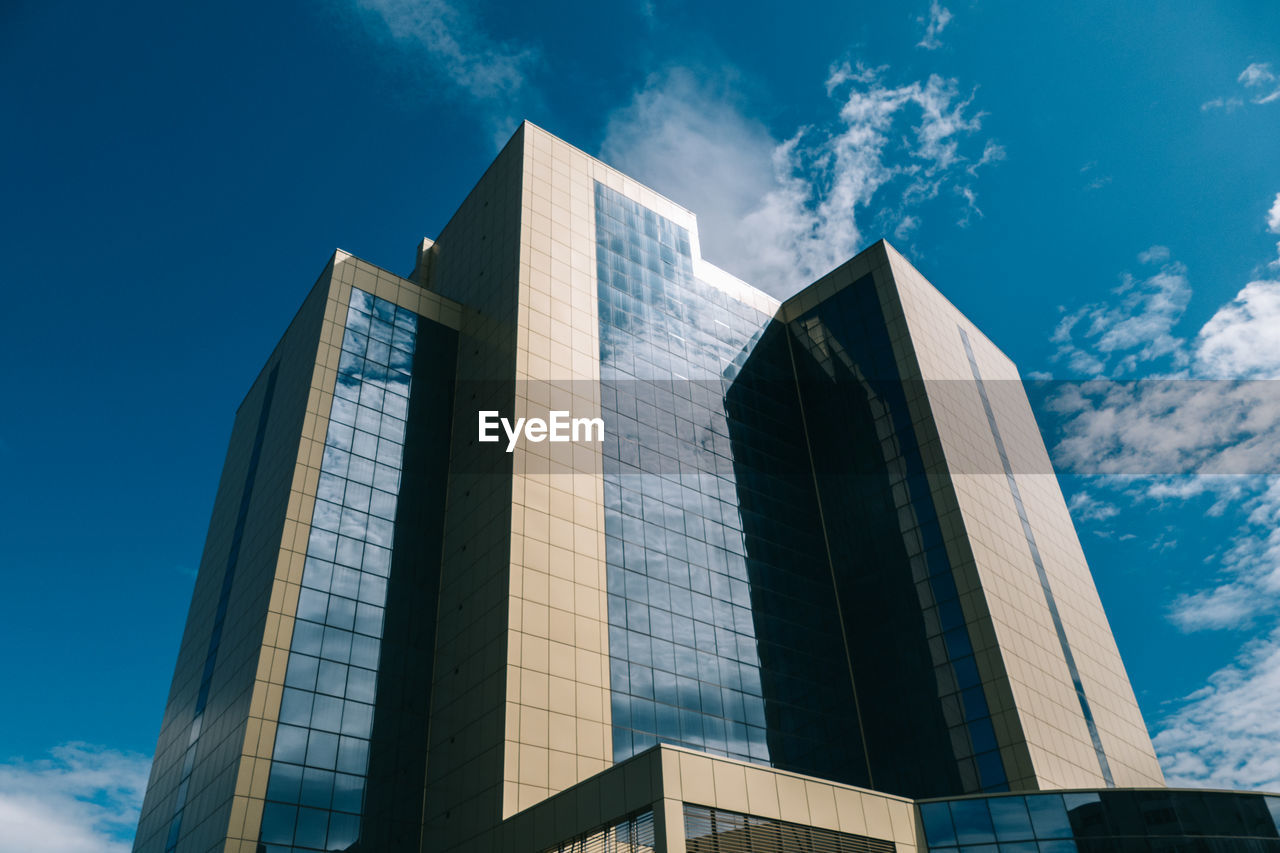 Low angle view of office building against sky