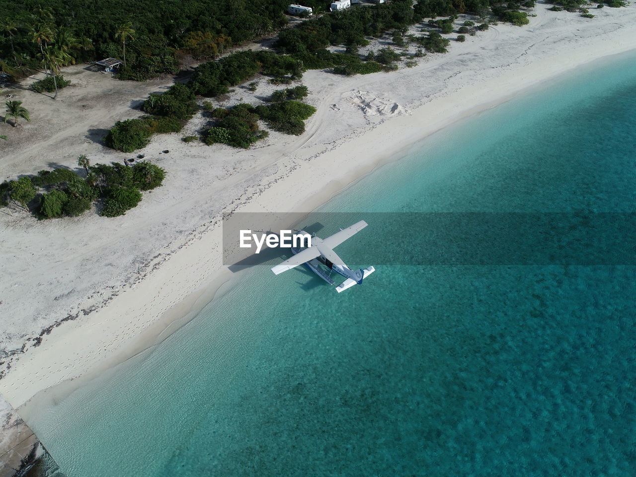 HIGH ANGLE VIEW OF NAUTICAL VESSEL ON BEACH