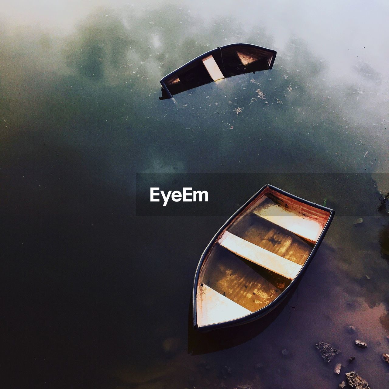 High angle view of abandoned rowboat in calm lake