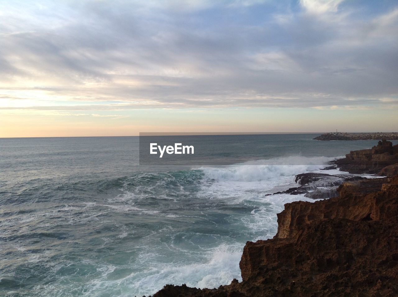 Scenic view of sea against dramatic sky