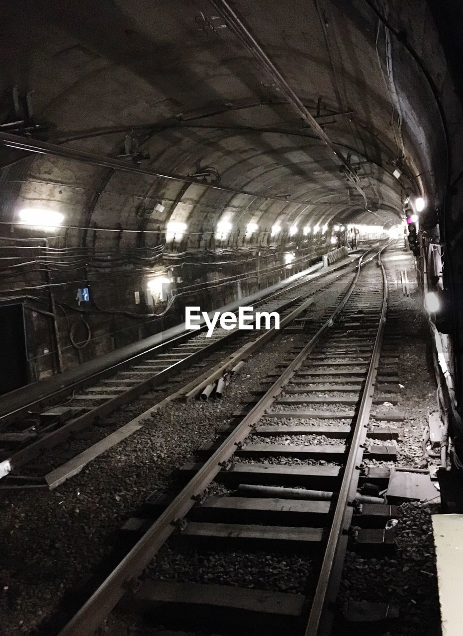 RAILROAD TRACKS ON RAILWAY STATION PLATFORM