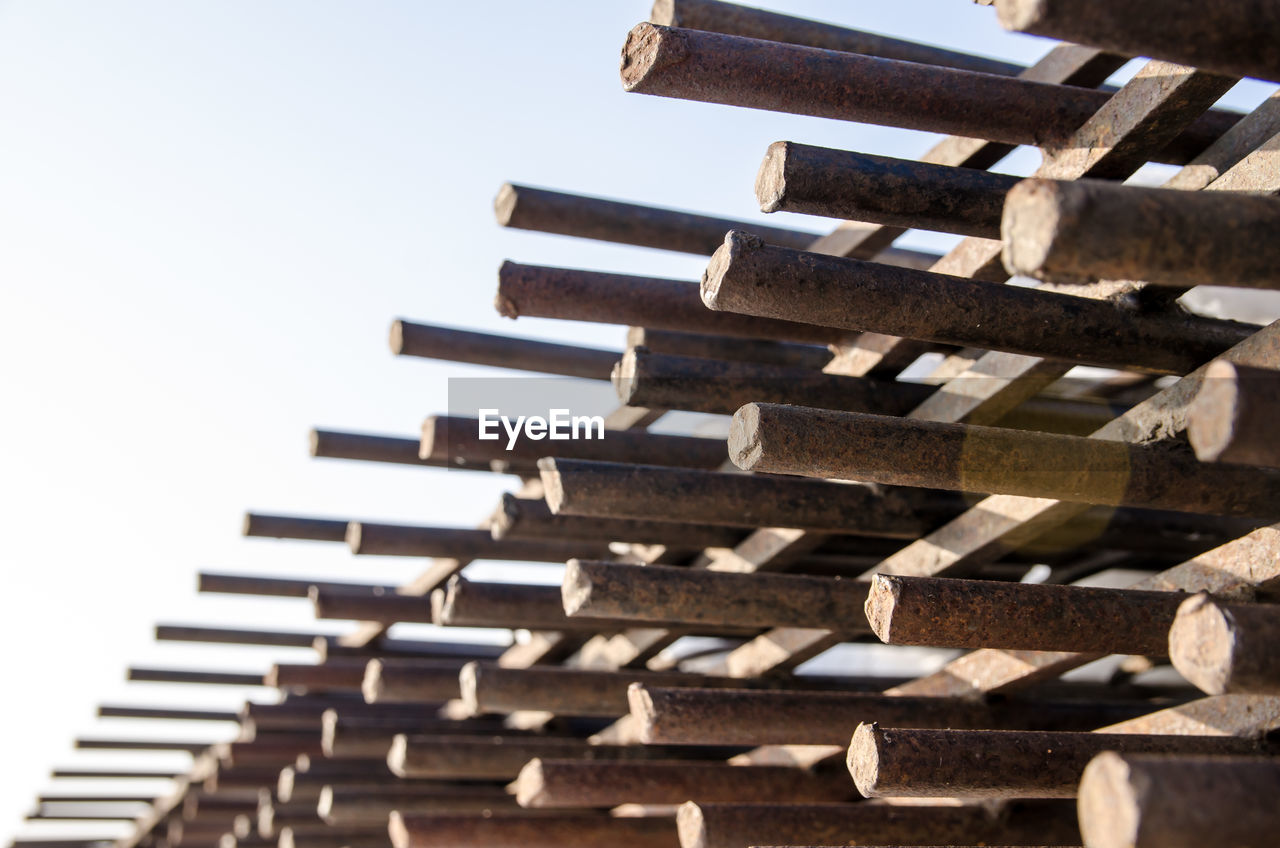 wood, architecture, no people, iron, large group of objects, sky, nature, industry, in a row, pattern, abundance, construction industry, day, outdoors, built structure, roof, clear sky