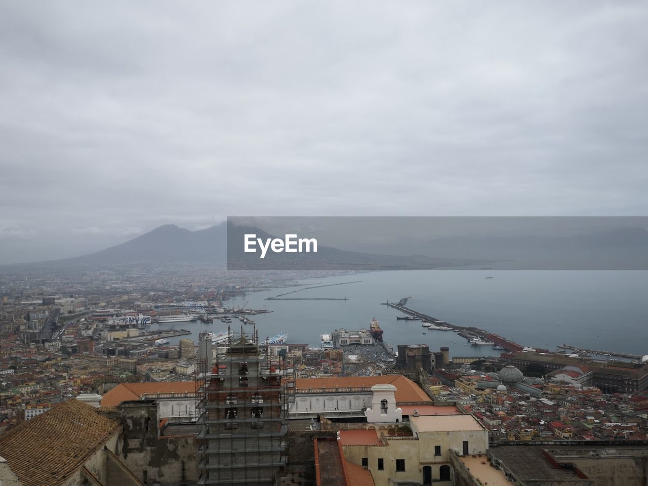 High angle view of townscape by sea against sky