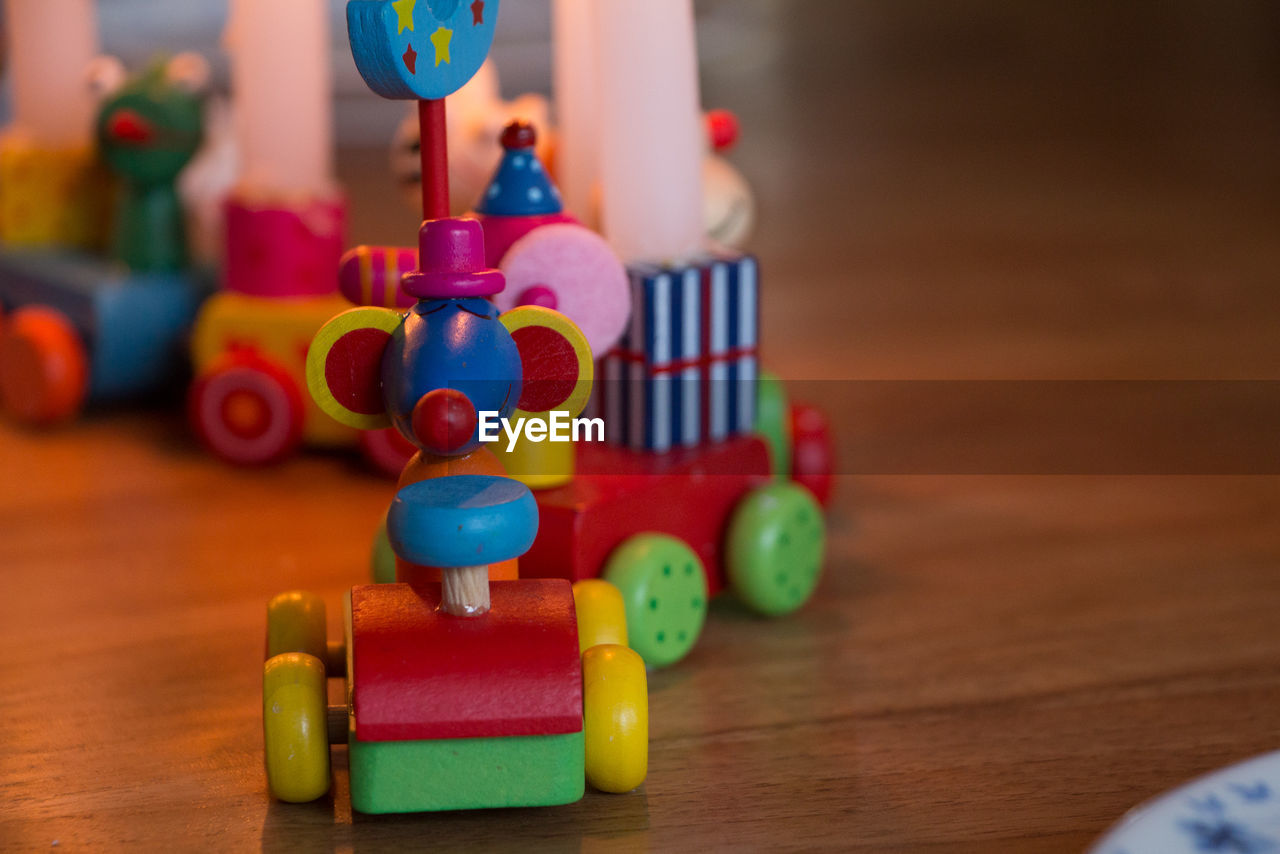 Close-up of toys on hardwood floor at home