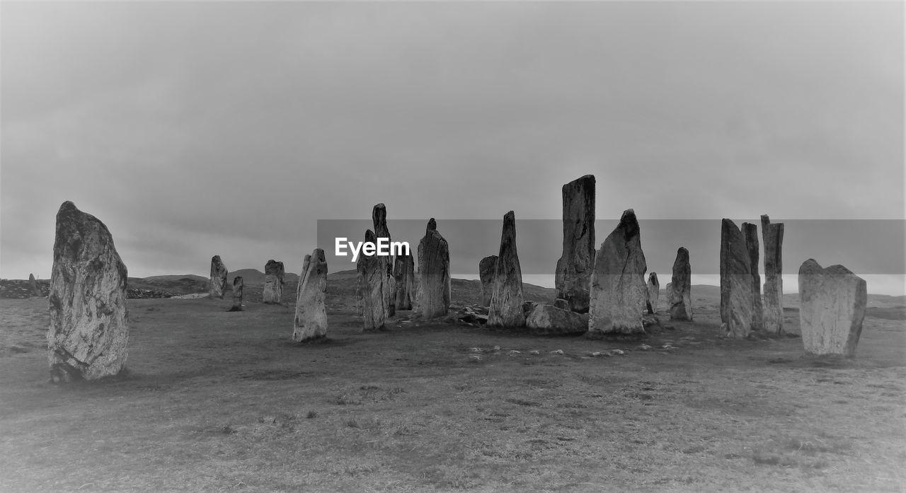 Megaliths on land against sky