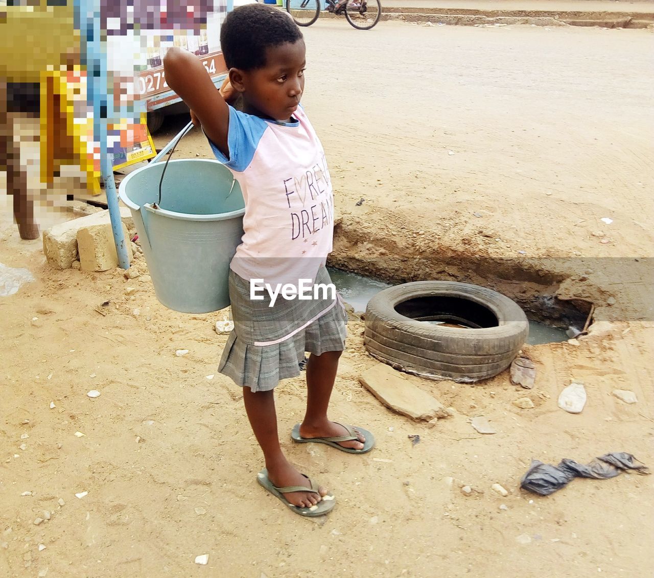FULL LENGTH OF CUTE GIRL STANDING IN PARK