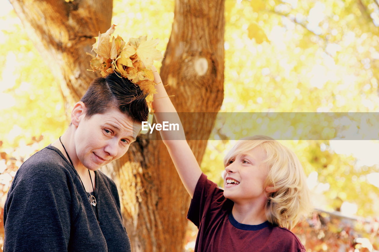 Happy mother and son in park during autumn