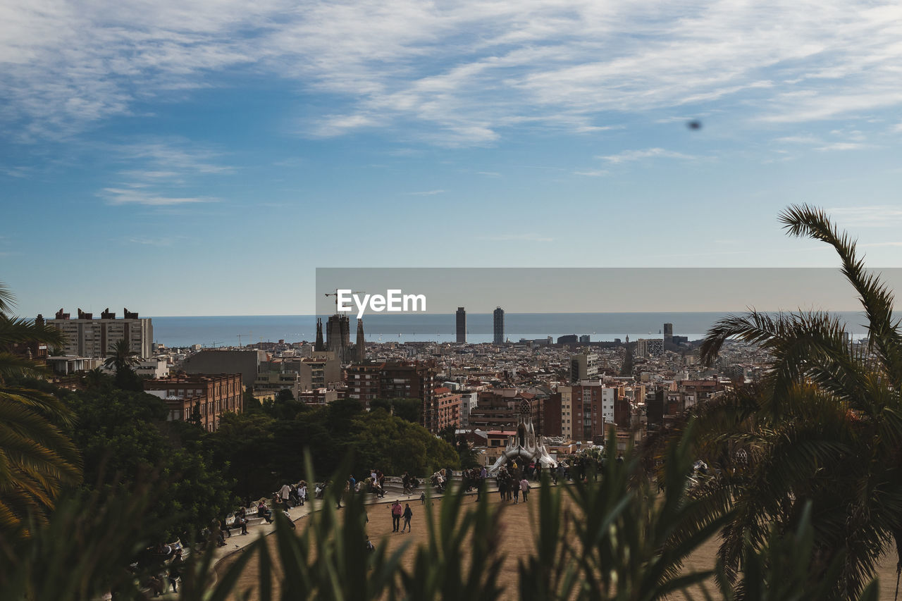 PANORAMIC SHOT OF CITY BUILDINGS BY SEA AGAINST SKY