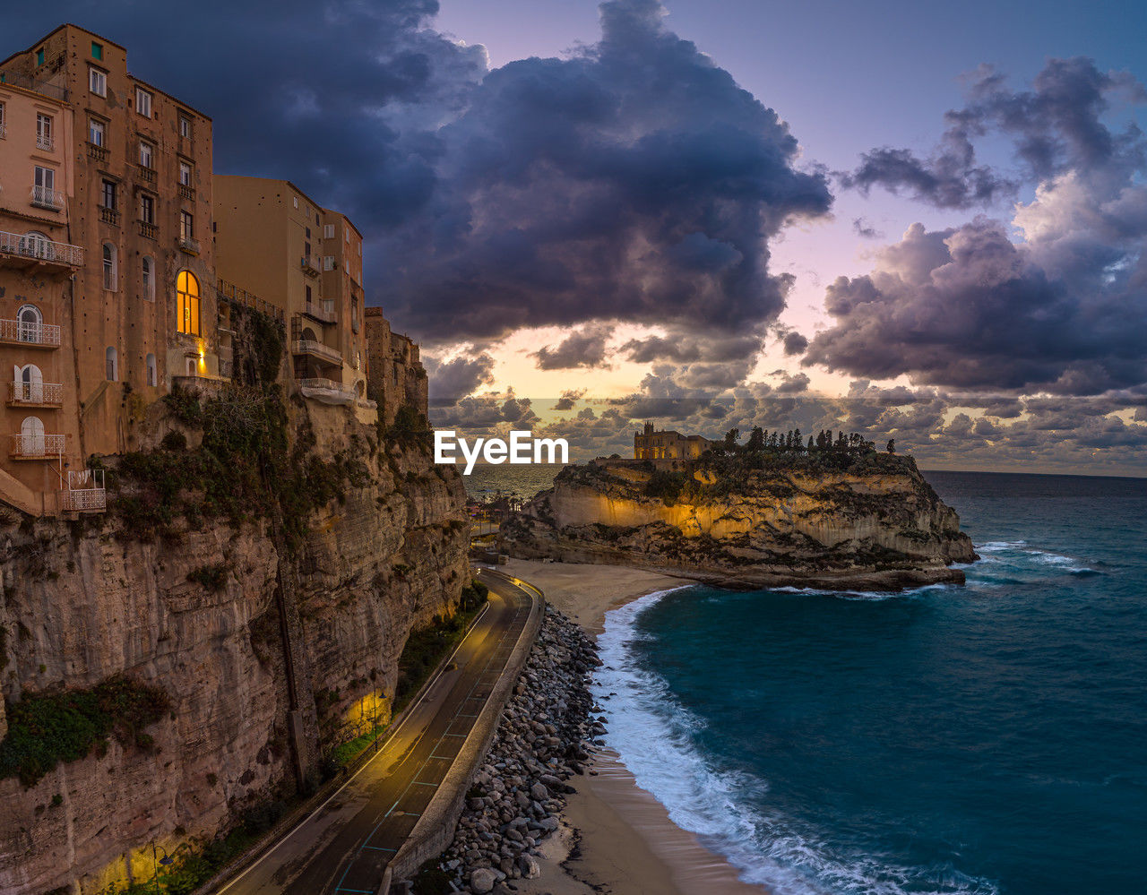 Tropea sunset along the coastline with dramatic clouds and cliffs