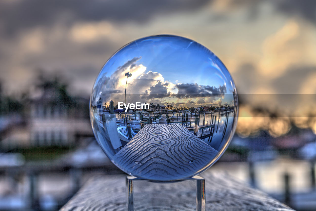 Crystal ball of boats docked at a marina near venetian bay in naples, florida at sunrise.