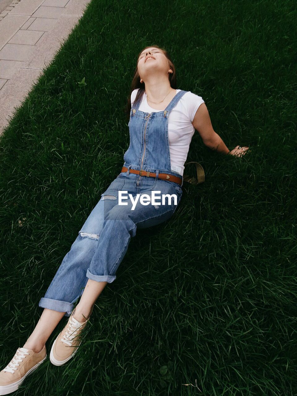 High angle view of woman sitting on field