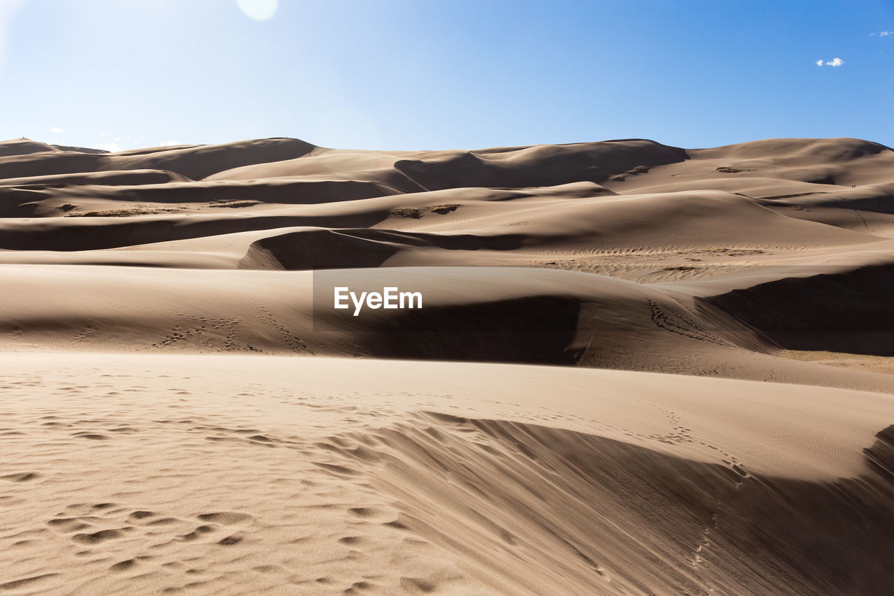 Sand dune in desert against sky