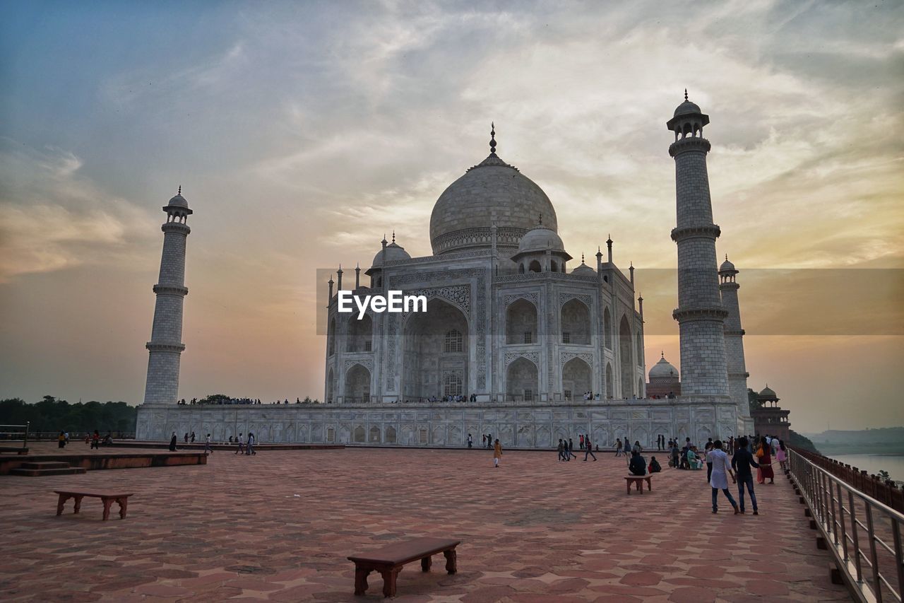 Tourists in front of historical taj mahal 