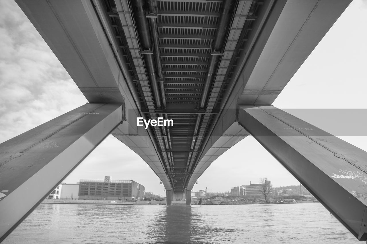 Low angle view of bridge over river in city