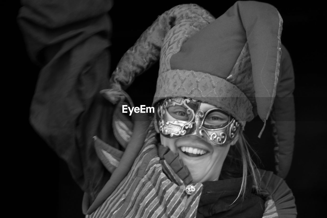 CLOSE-UP PORTRAIT OF SMILING GIRL WITH MASK