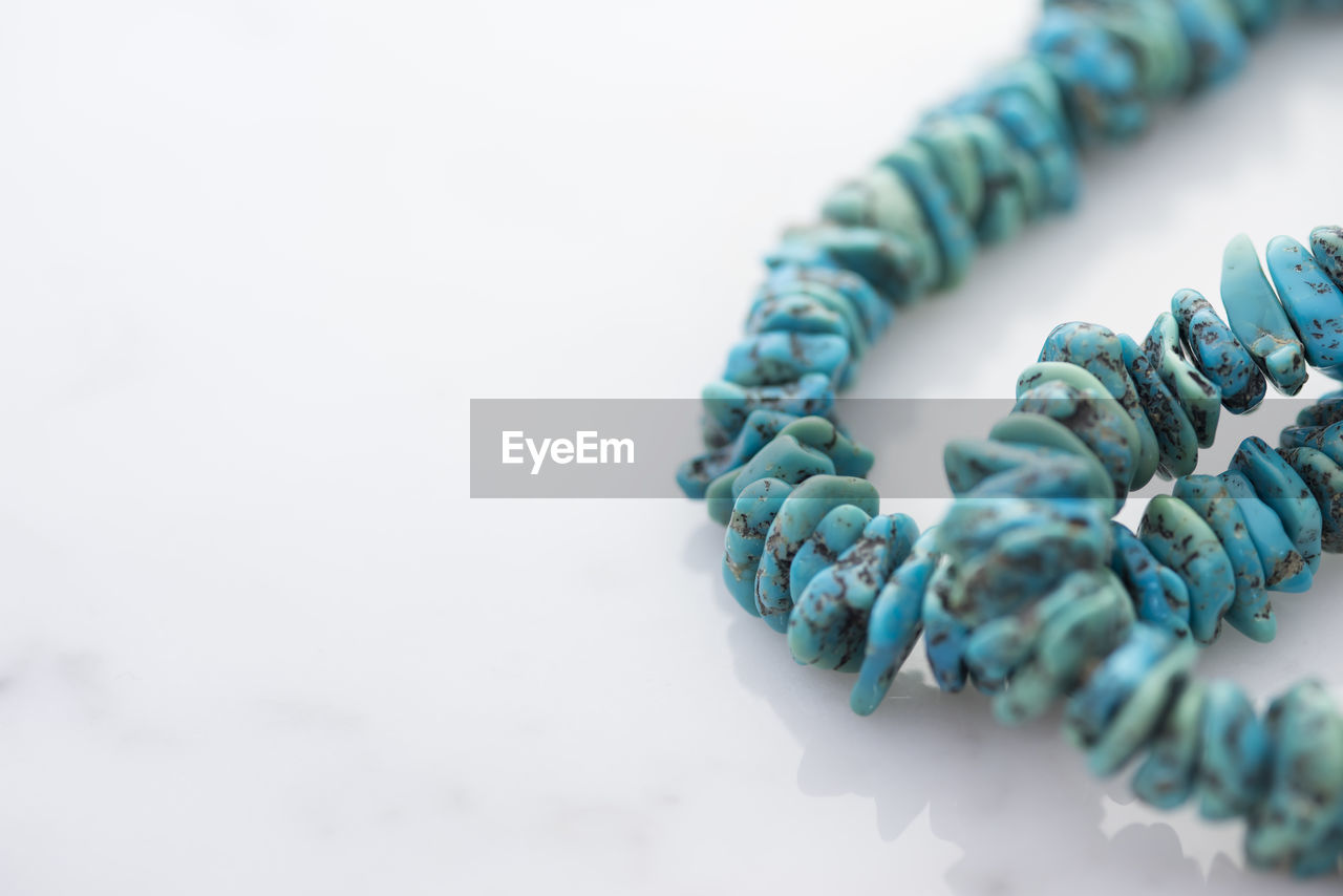 Close-up of stone bracelets on white background