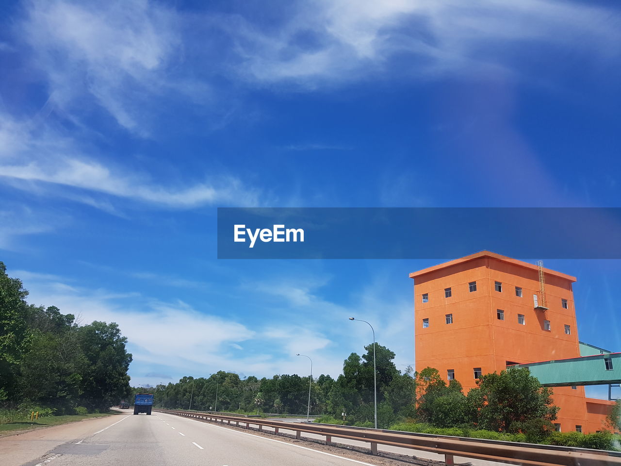 ROAD BY BUILDINGS AGAINST SKY