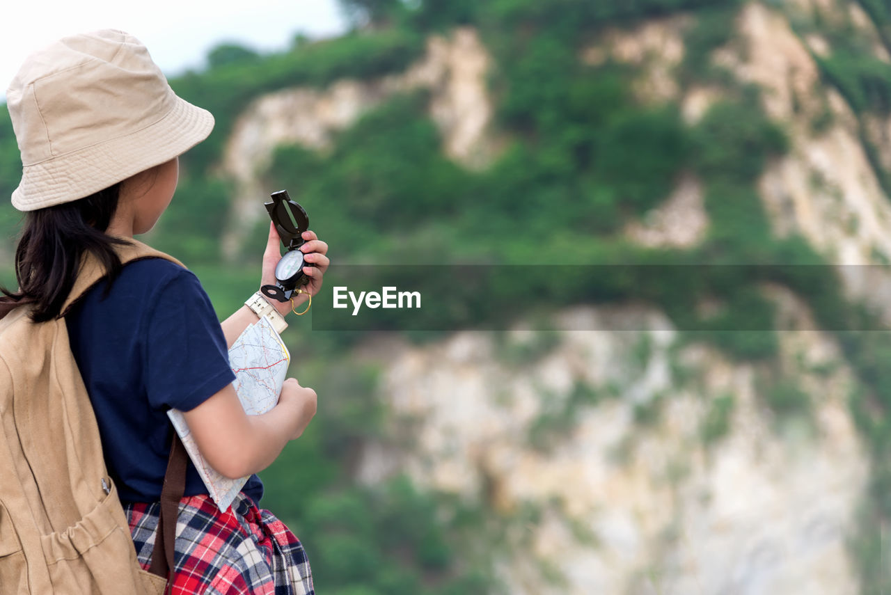 WOMAN PHOTOGRAPHING WITH MOBILE PHONE