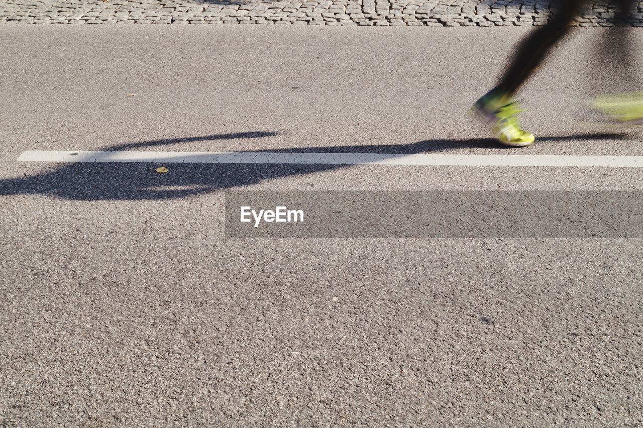 Blurred motion of person running on street