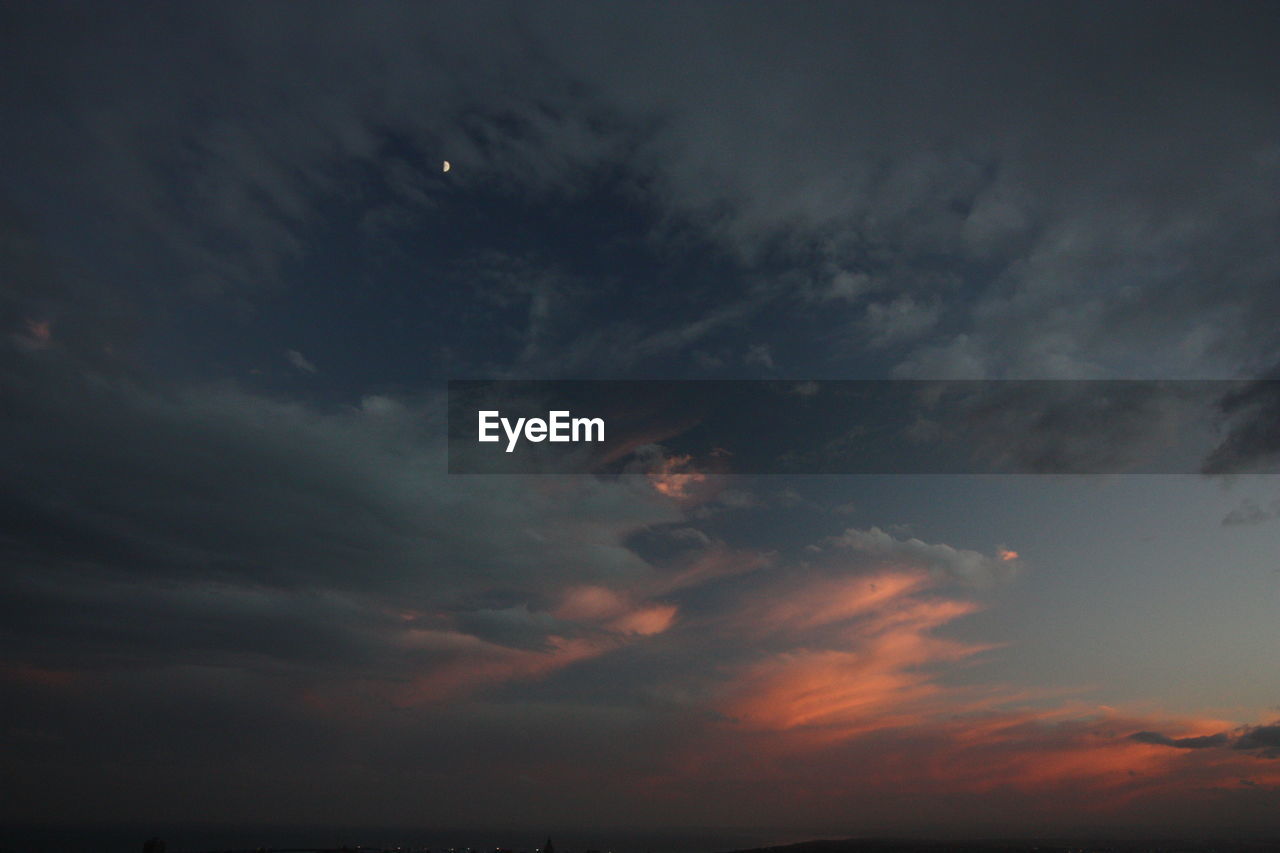 LOW ANGLE VIEW OF MOON AT SKY