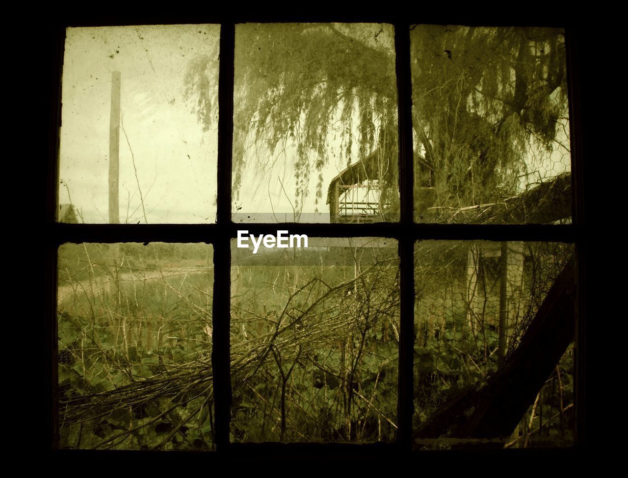 Abandoned cottage seen through window