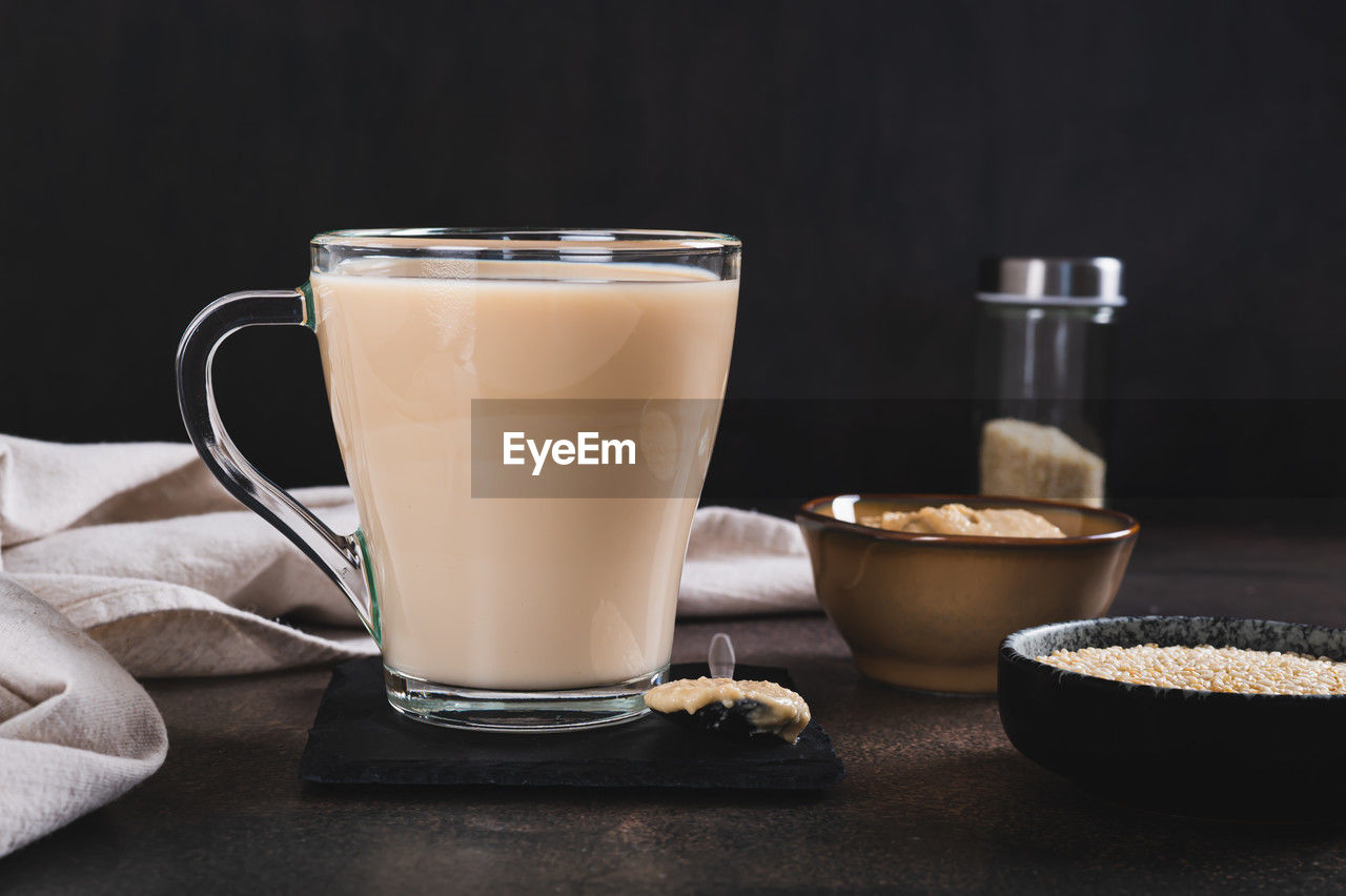food and drink, drink, refreshment, food, dairy, milk, studio shot, drinking glass, glass, coffee, household equipment, indoors, black background, still life, freshness, cup, wellbeing, no people, hot drink, table, healthy eating, latte, crockery, mug, roasted coffee bean, copy space