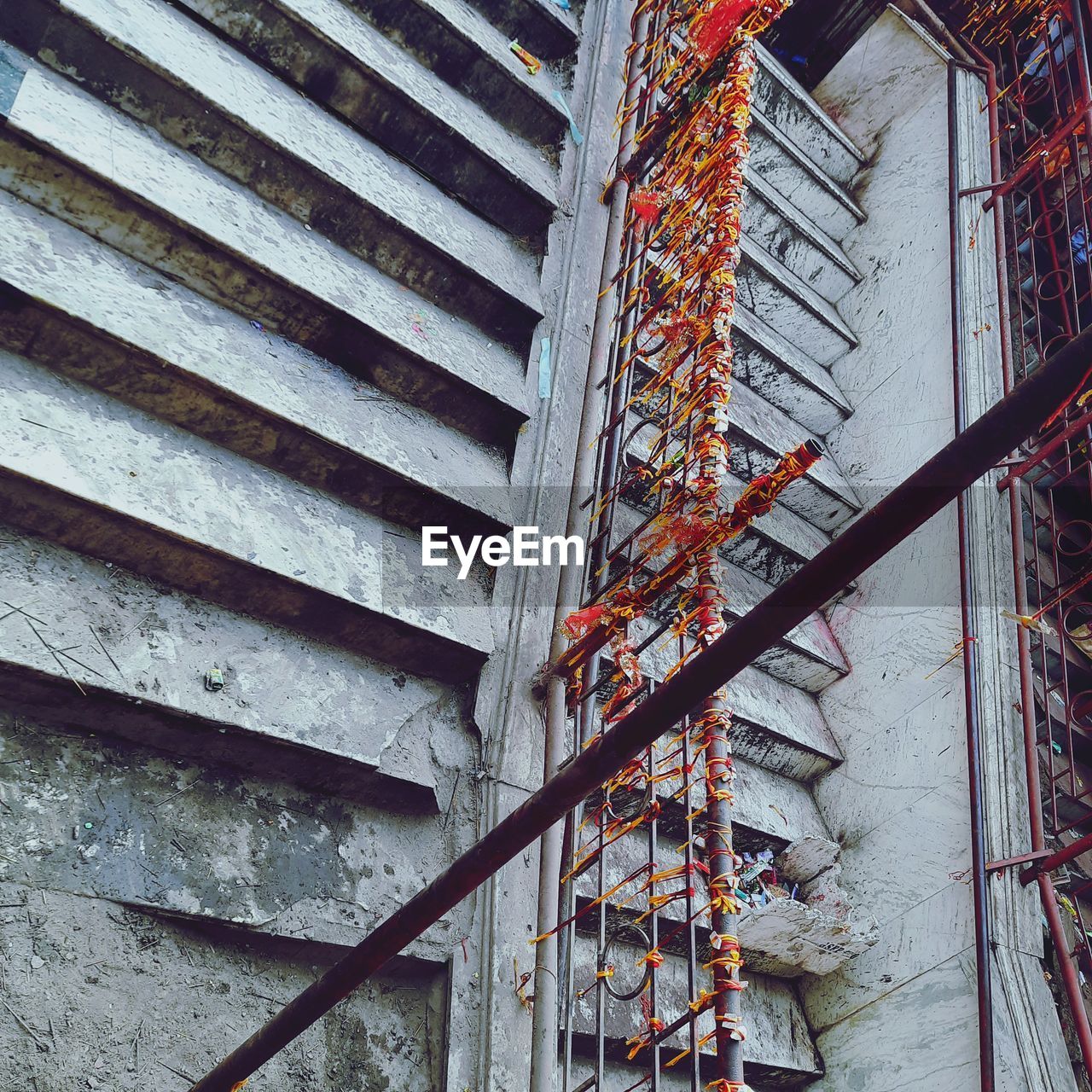 architecture, built structure, staircase, steps and staircases, low angle view, building exterior, day, no people, iron, metal, construction site, building, outdoors, urban area, facade, stairs, construction industry, pattern, development, industry, wall, railing, scaffolding