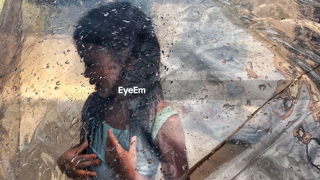 HIGH ANGLE VIEW OF WOMAN ON WET FLOOR