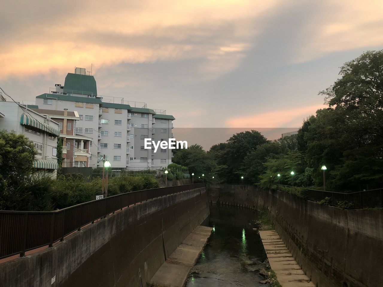 CANAL AMIDST BUILDINGS AGAINST SKY