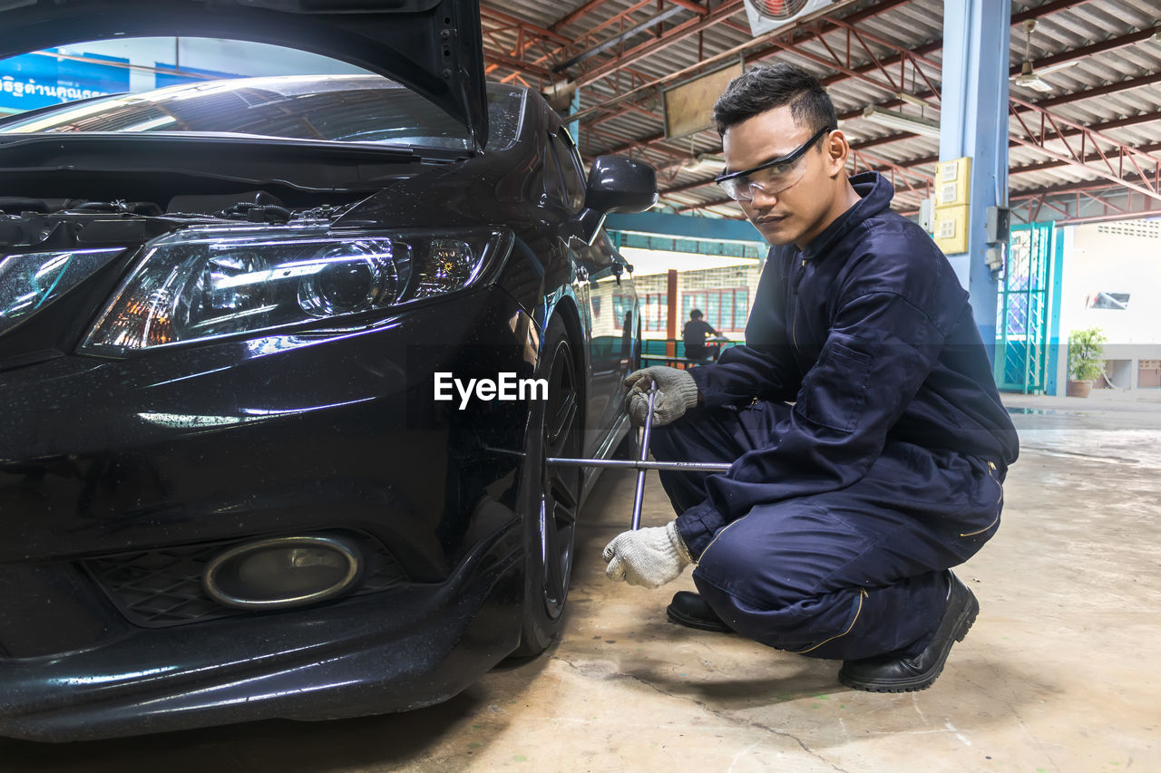 Mechanic repairing car in auto repair shop