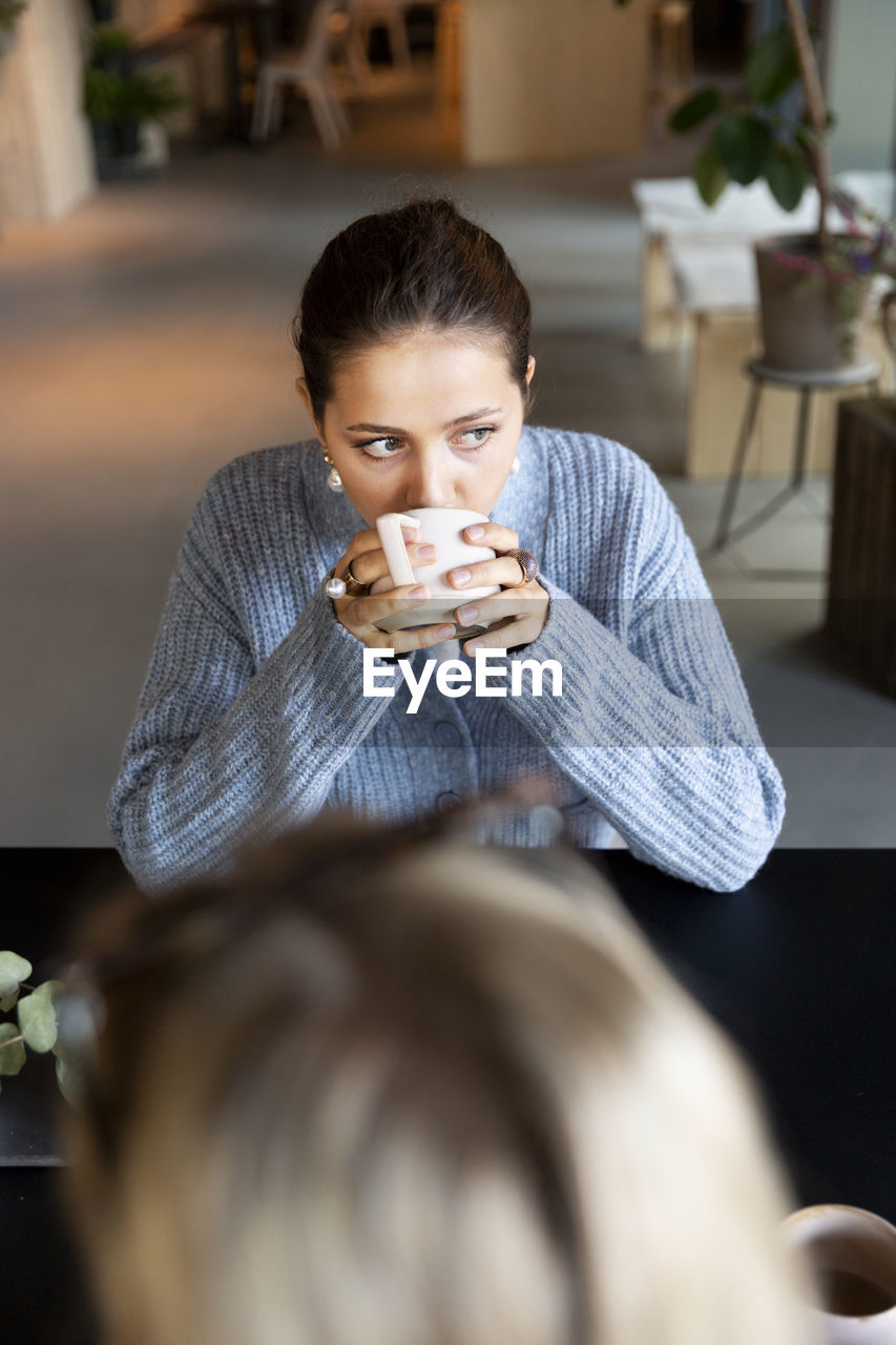 Woman drinking coffee in cafe