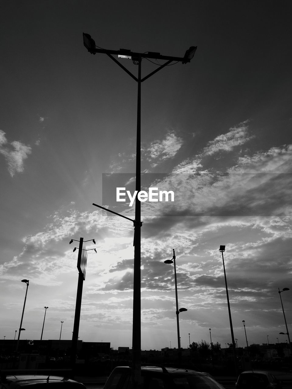 LOW ANGLE VIEW OF STREET LIGHT AGAINST CLOUDY SKY