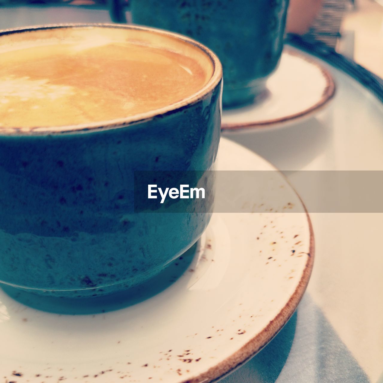 CLOSE-UP OF COFFEE CUP ON TABLE