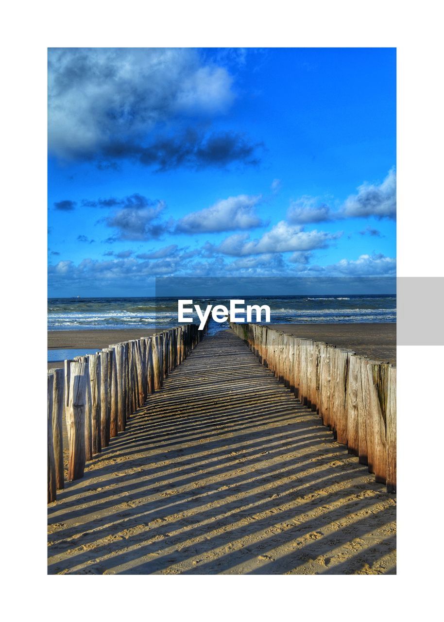 SCENIC VIEW OF BEACH AGAINST BLUE SKY