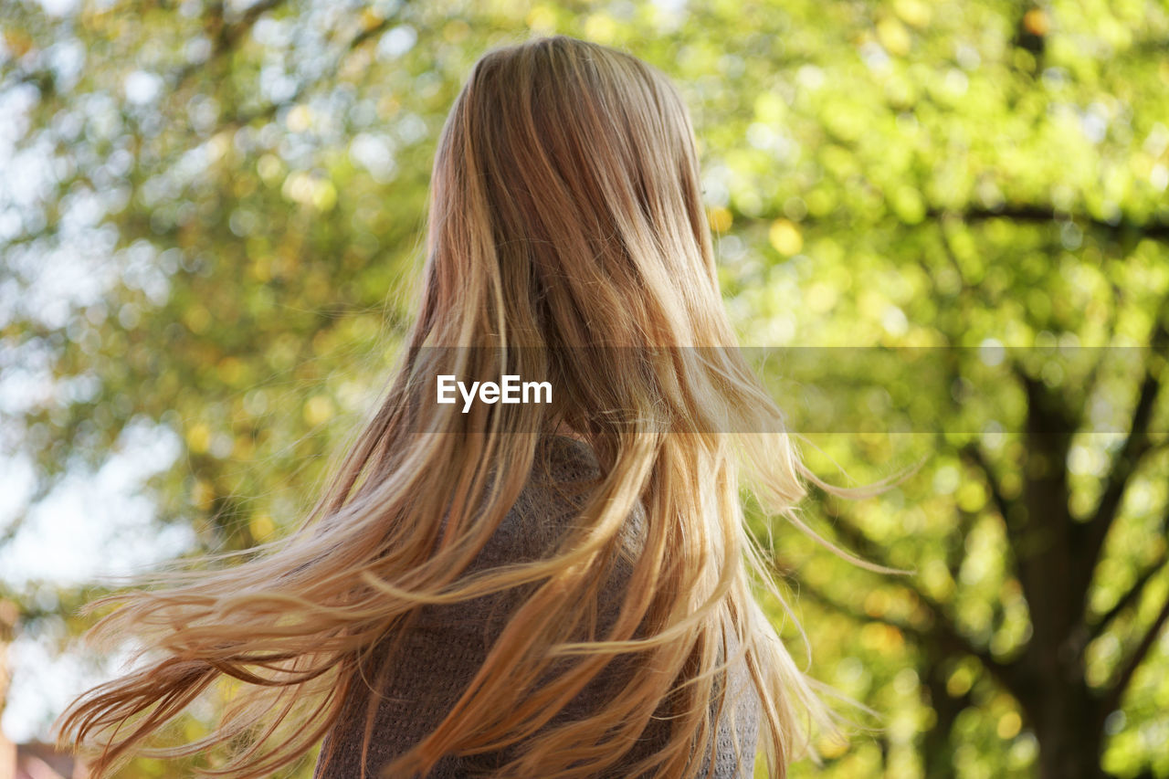 Girl shaking her long blond hair