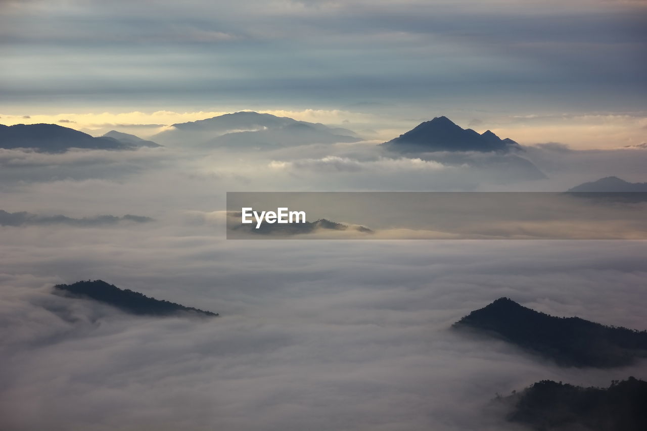 Scenic view of majestic mountains against sky during sunset