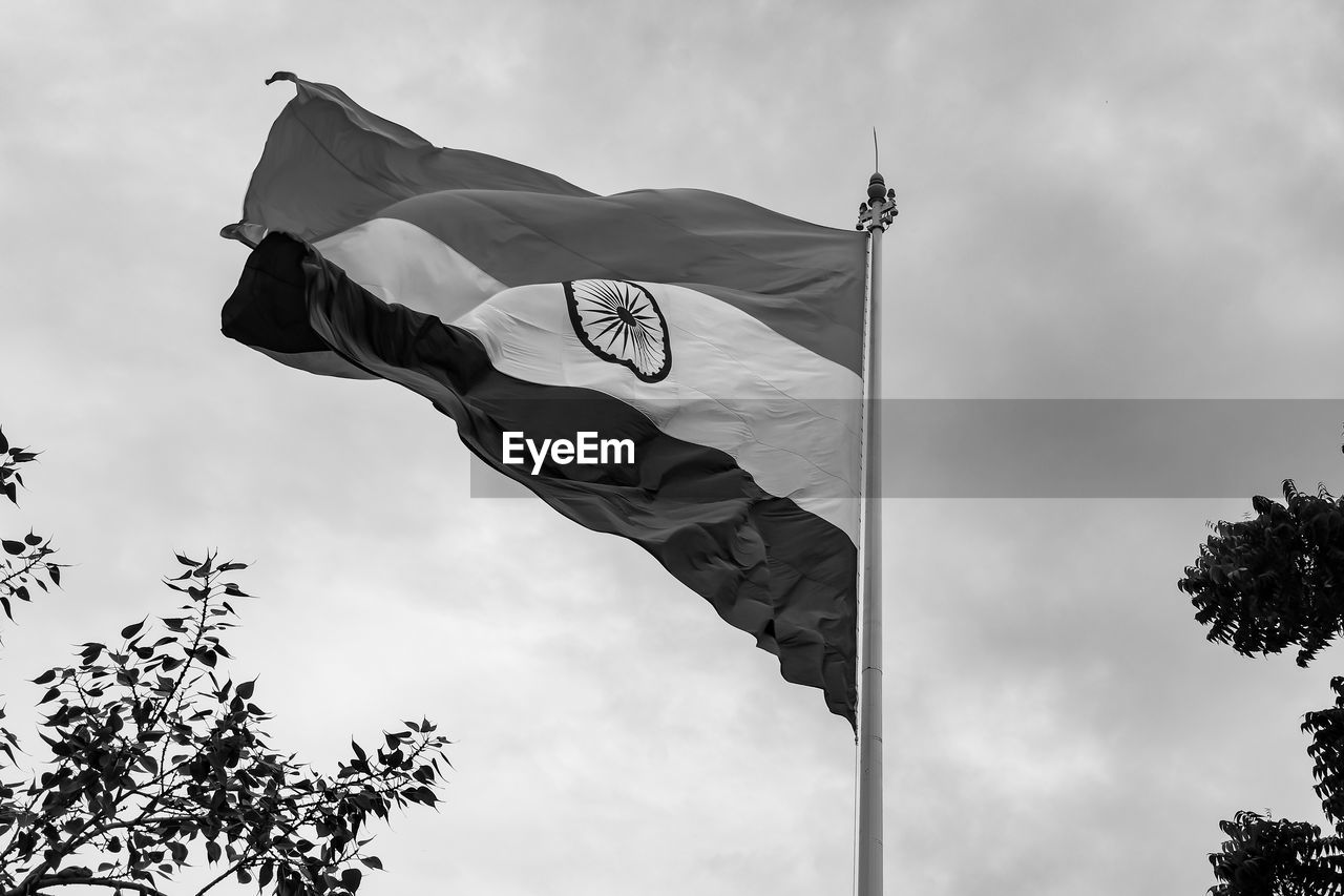 India flag flying high at connaught place with pride in blue sky, india flag fluttering, indian flag