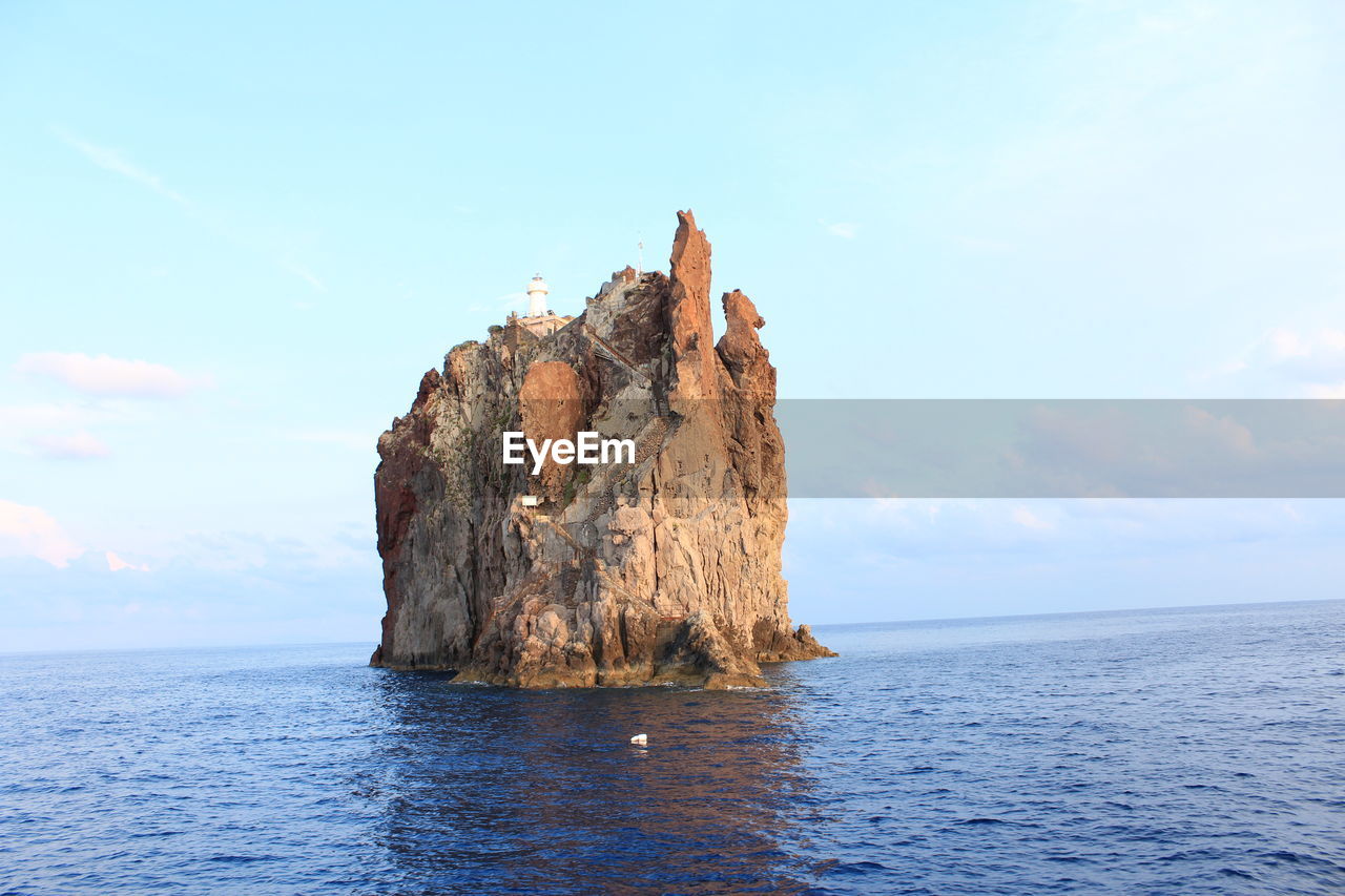 water, sea, sky, cliff, rock, beauty in nature, scenics - nature, nature, ocean, coast, rock formation, tranquility, cloud, tranquil scene, land, terrain, shore, horizon over water, blue, no people, horizon, idyllic, islet, day, bay, tower, non-urban scene, outdoors, formation, beach, body of water, travel destinations, vacation, stack rock, travel, waterfront, remote