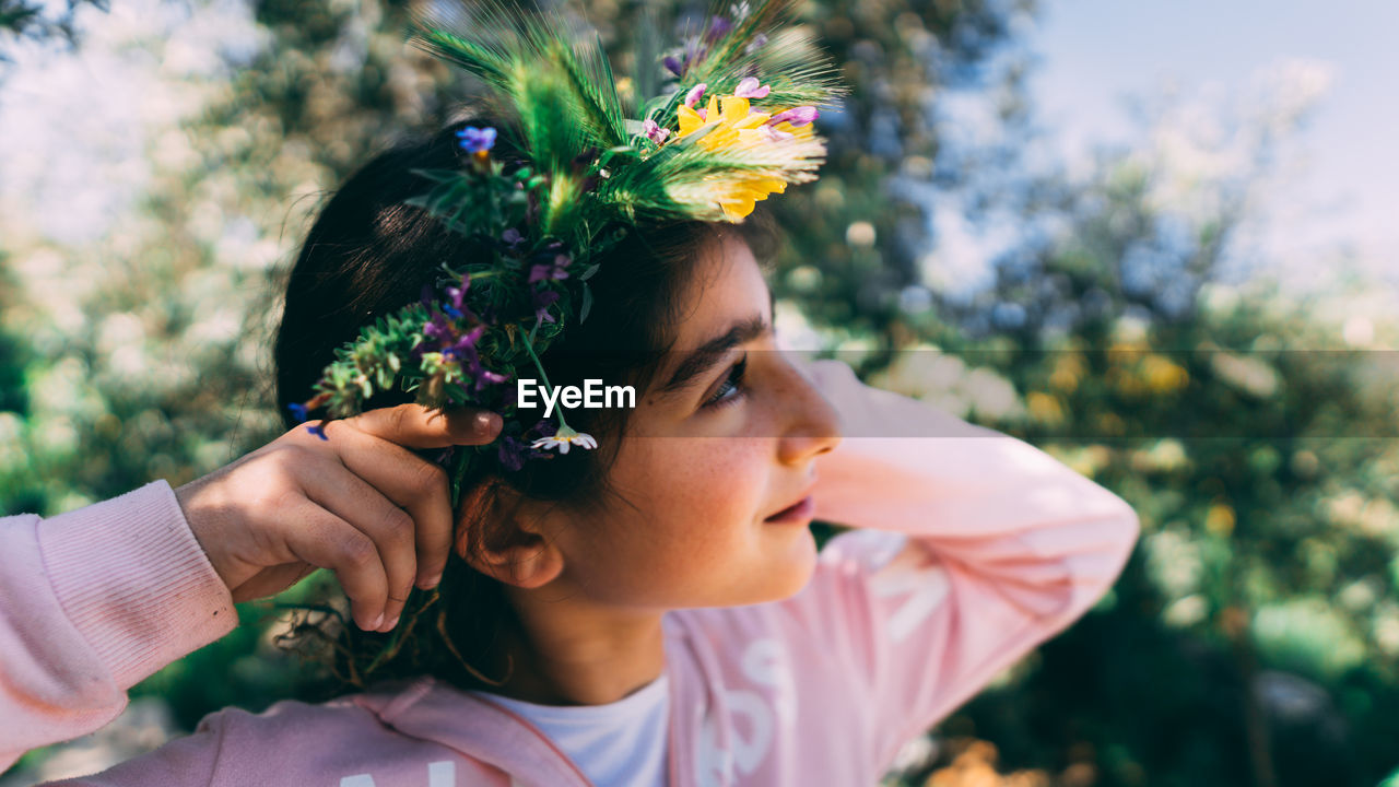 Close-up of girl wearing flowers on hair