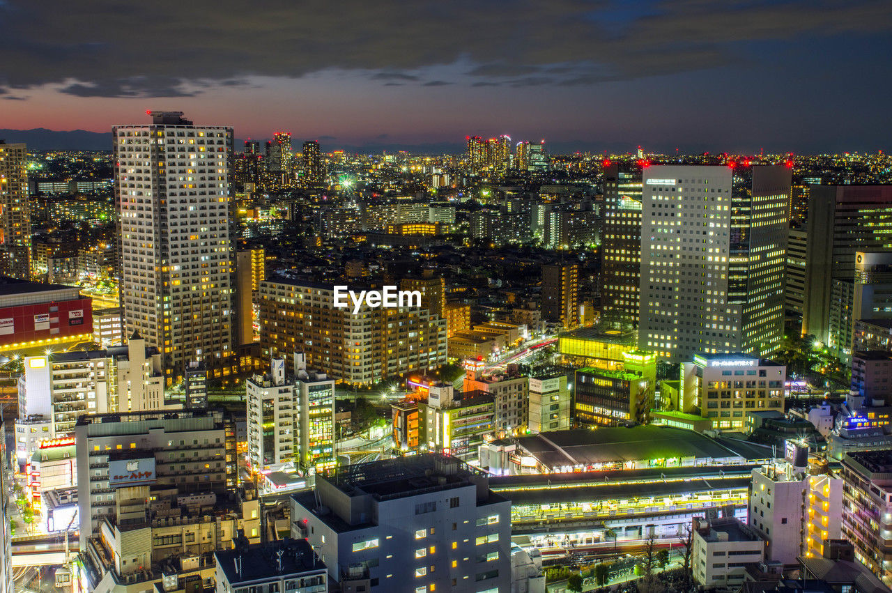 High angle view of illuminated buildings in city at night