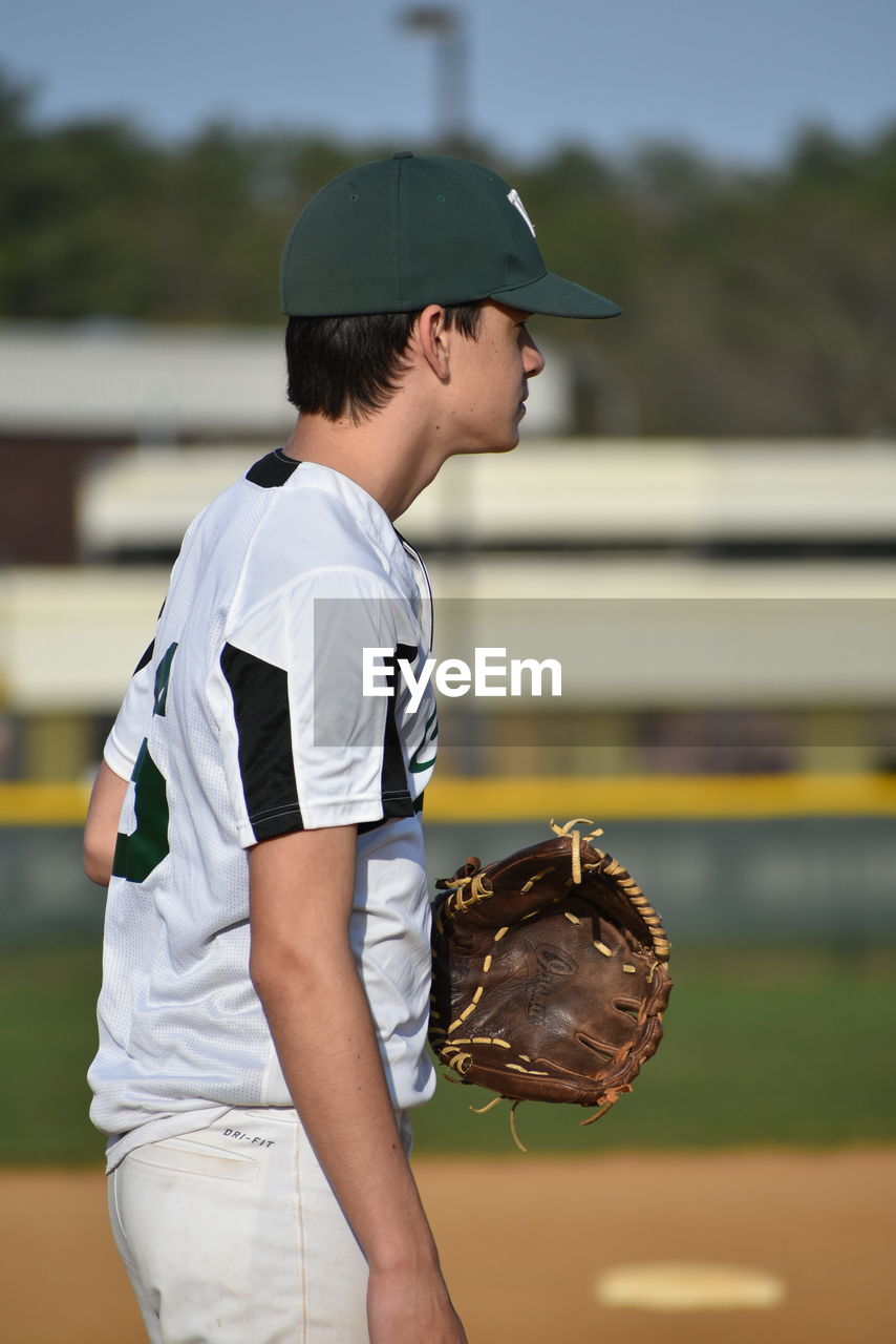 Side view of baseball player wearing gloves