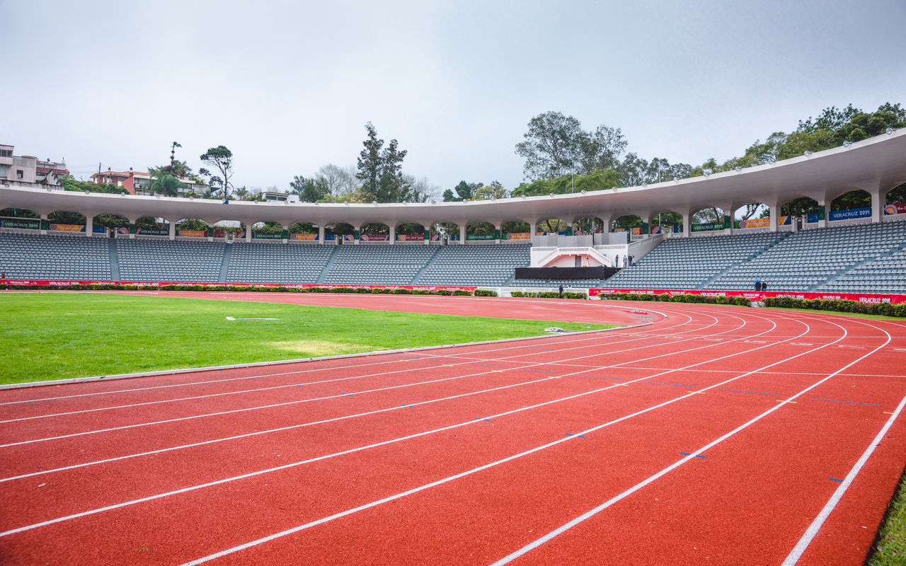 running track, sports track, sport, day, track and field, sports race, competition, stadium, red, outdoors, grass, no people, sky, tree