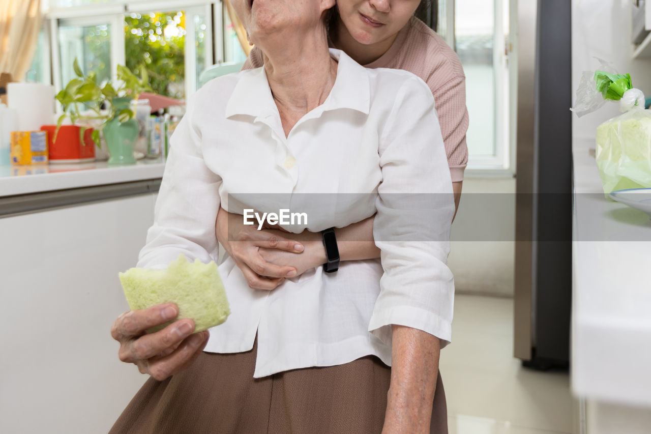 midsection of woman holding food in office