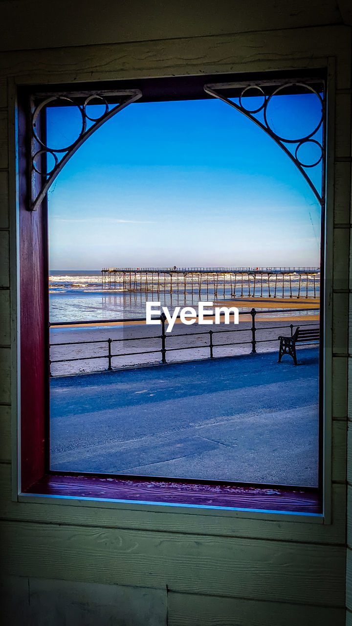 blue, window, architecture, light, sky, water, built structure, sea, nature, reflection, day, display device, interior design, outdoors, window covering, no people, travel destinations, building exterior, horizon